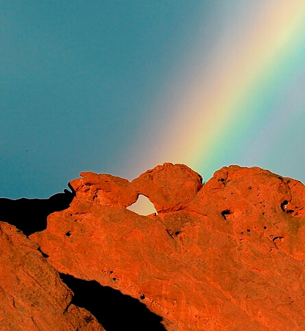 Kissing Camels formation in front of a rainbow